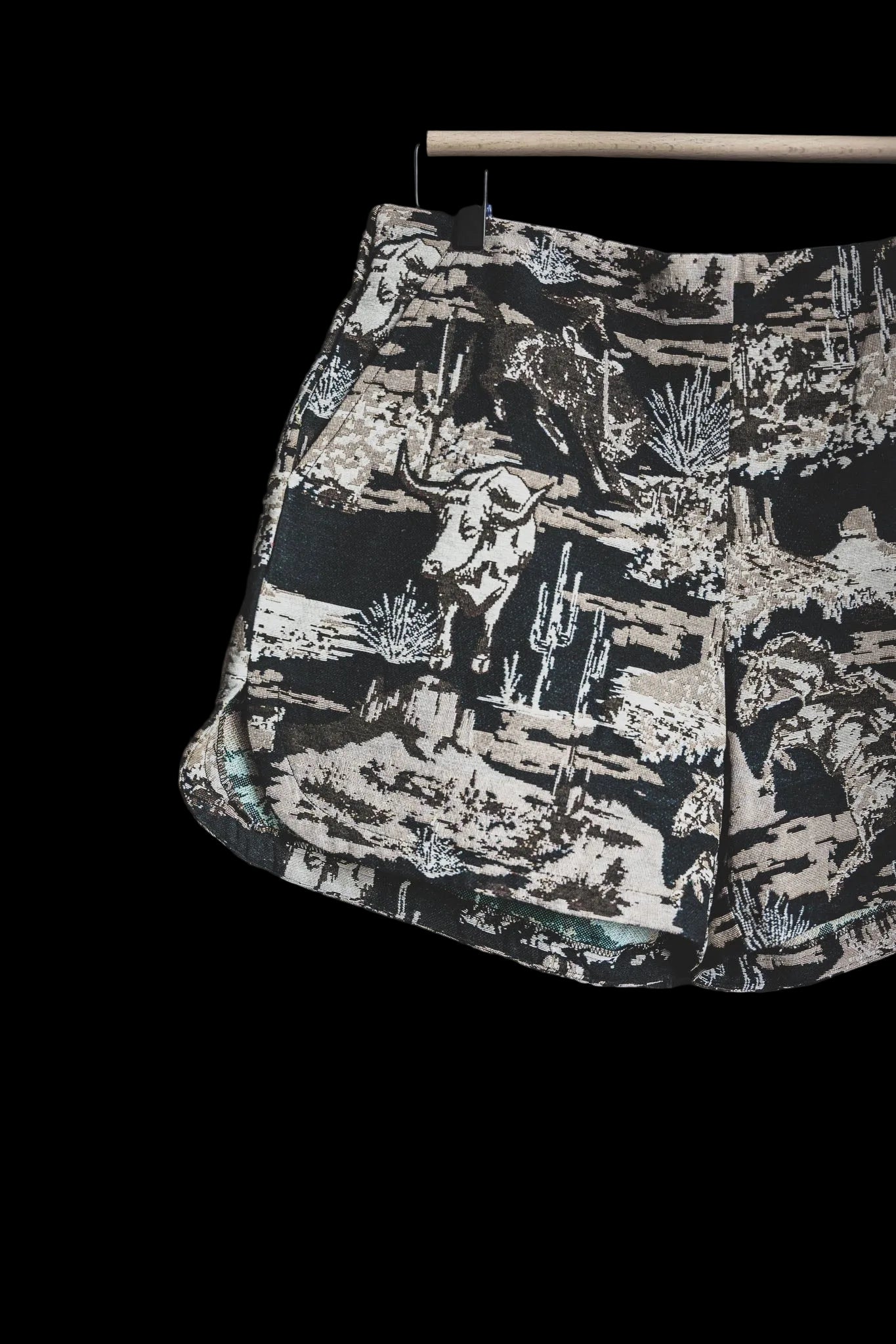 Shorts with a nature-themed print on a dark background