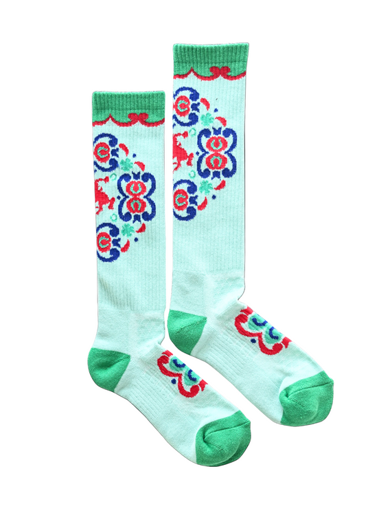 Pair of knee-high socks with colorful butterfly design on a light blue background