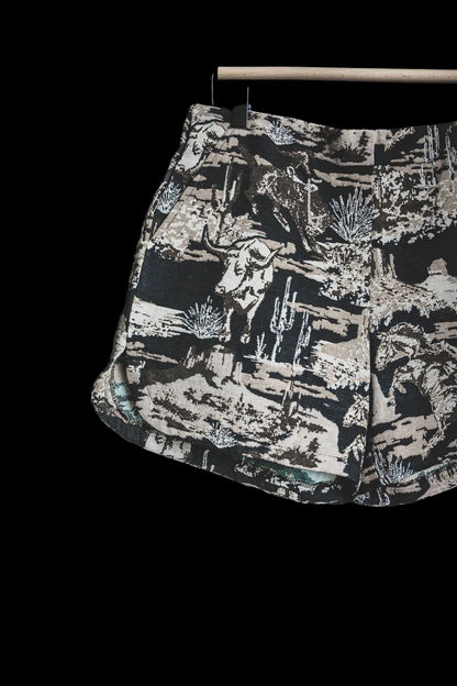 Shorts with a nature-themed print on a dark background